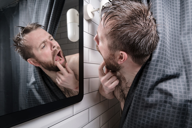 Patient checking their mouth for gum disease