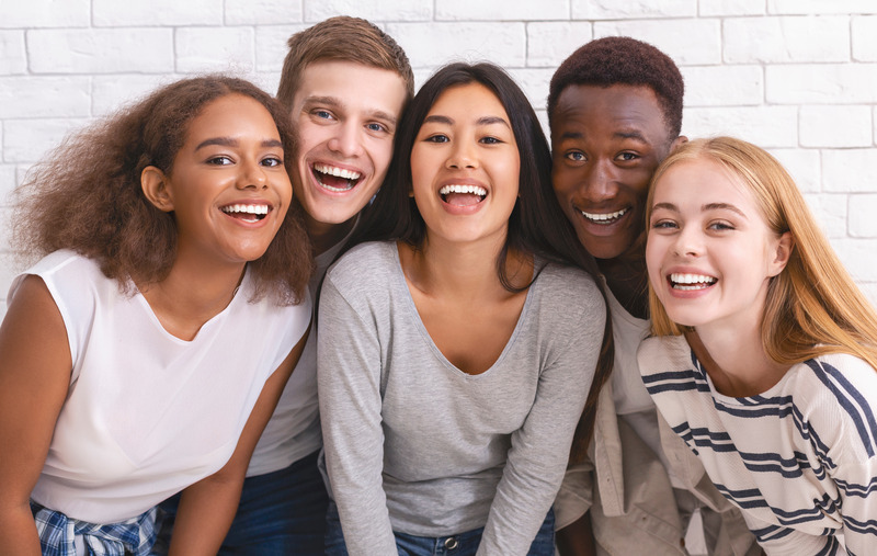 Teen patients smiling after cosmetic dentistry